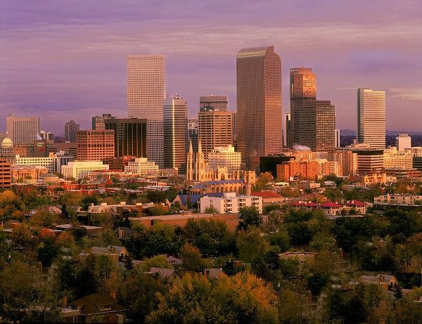 Denver-Colorado skyline glistens in early morning during sunrise against the Rocky Mountains